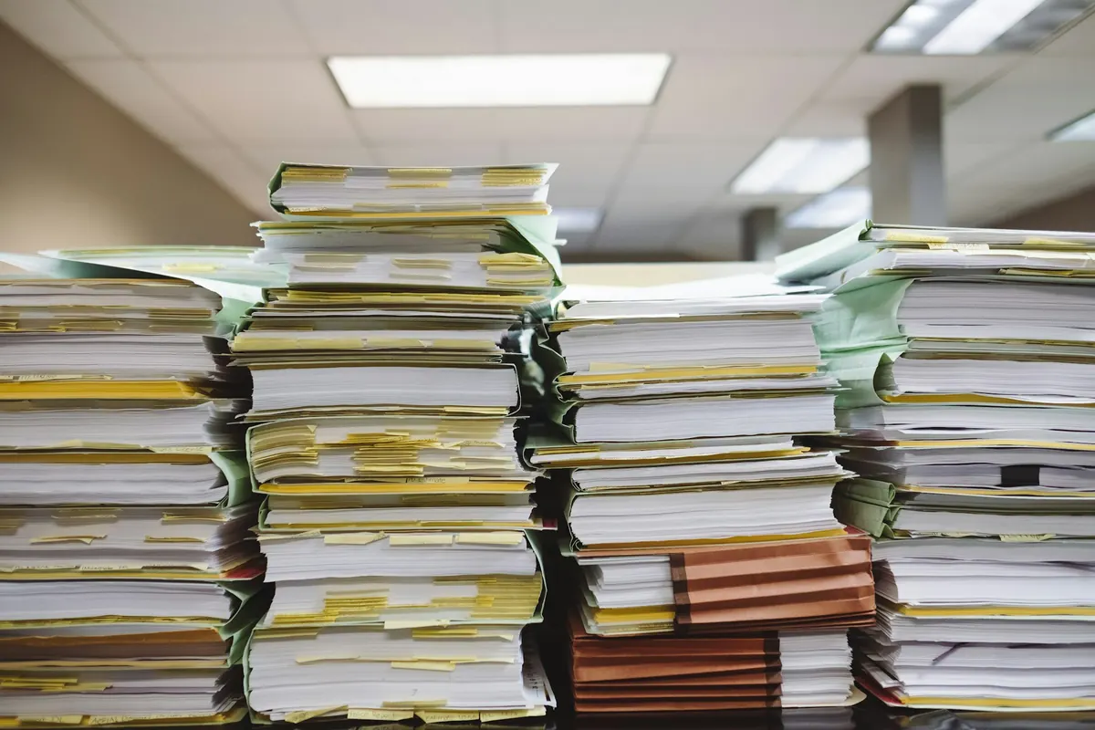 Tall stacks of paper folders with yellow tabs